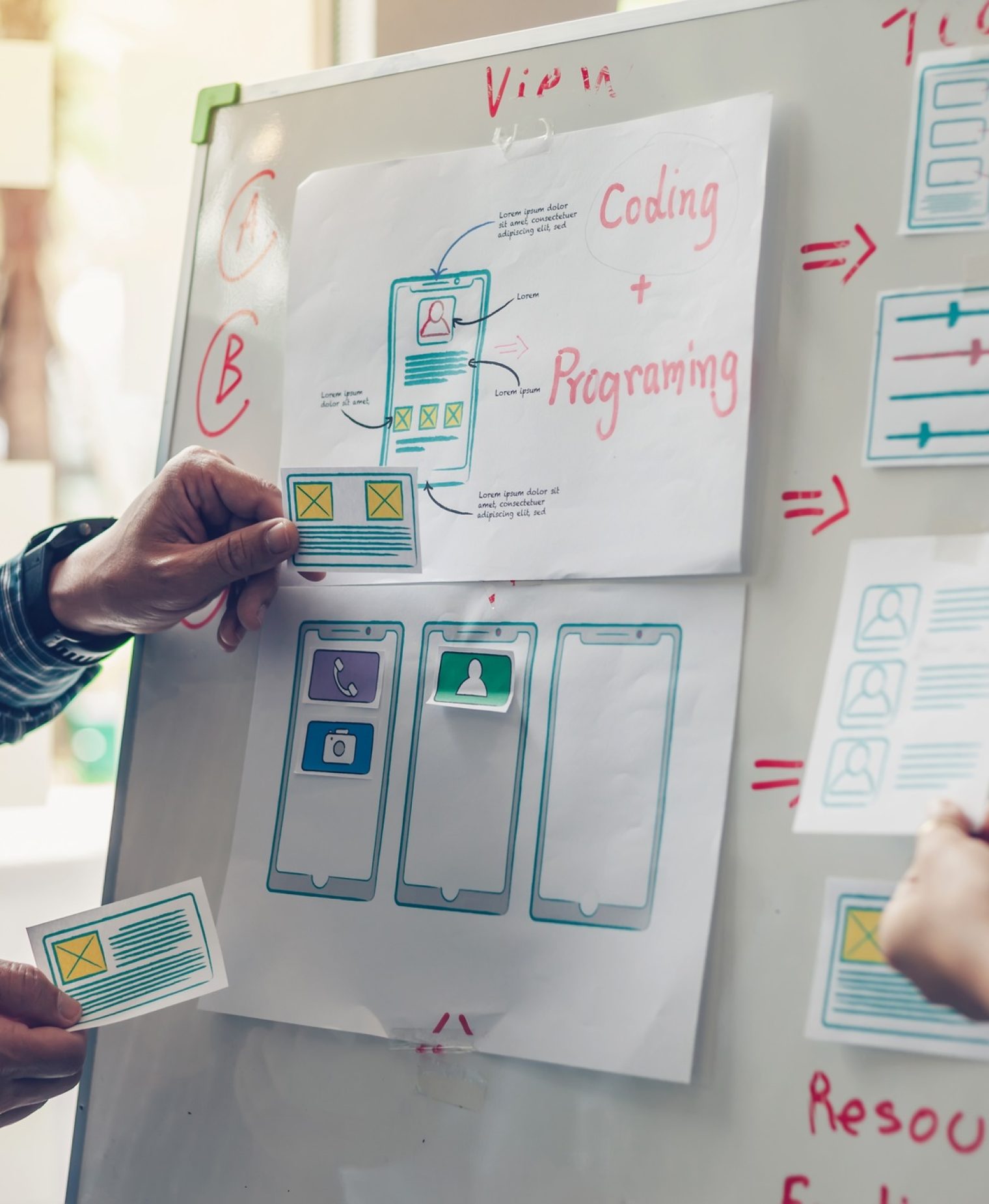 Designer team drawing website ux app development application for mobile phone.