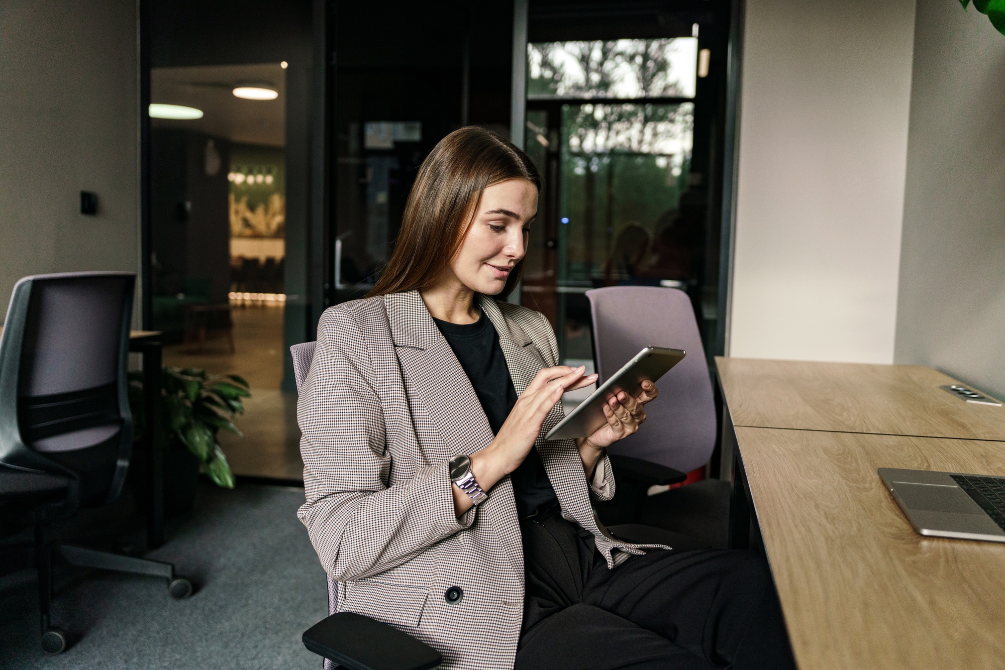 A confident person works in a coworking space. Smart freelancer startup project. A creative female e