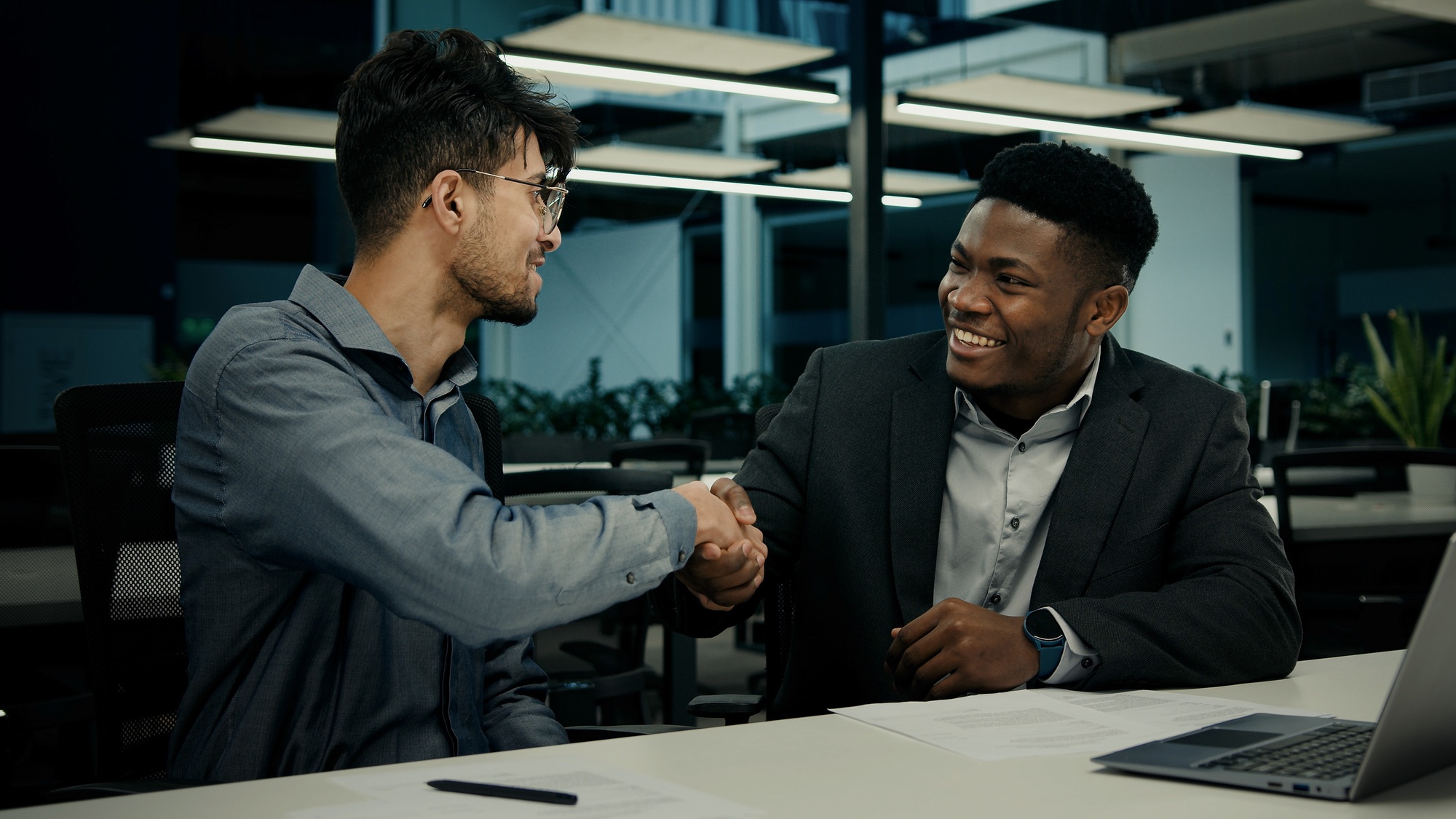 Businessman african man lawyer mentor help male indian client with computer work consult customer